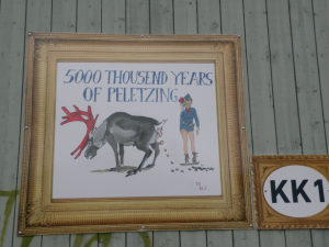Artist rendering of reindeer defecating and a person standing behind it. The text in the illustration reads "5000 THOUSAND YEARS OF PELETIZING"